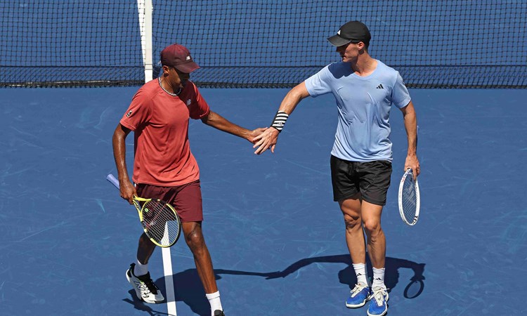 Joe Salisbury and Rajeev Ram high fiving on court at the US Open