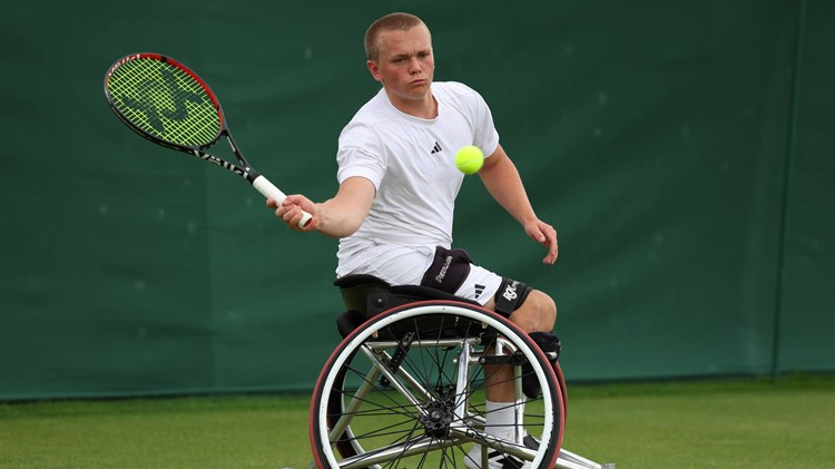 Ben Bartram hits a forehand at Wimbledon 2024