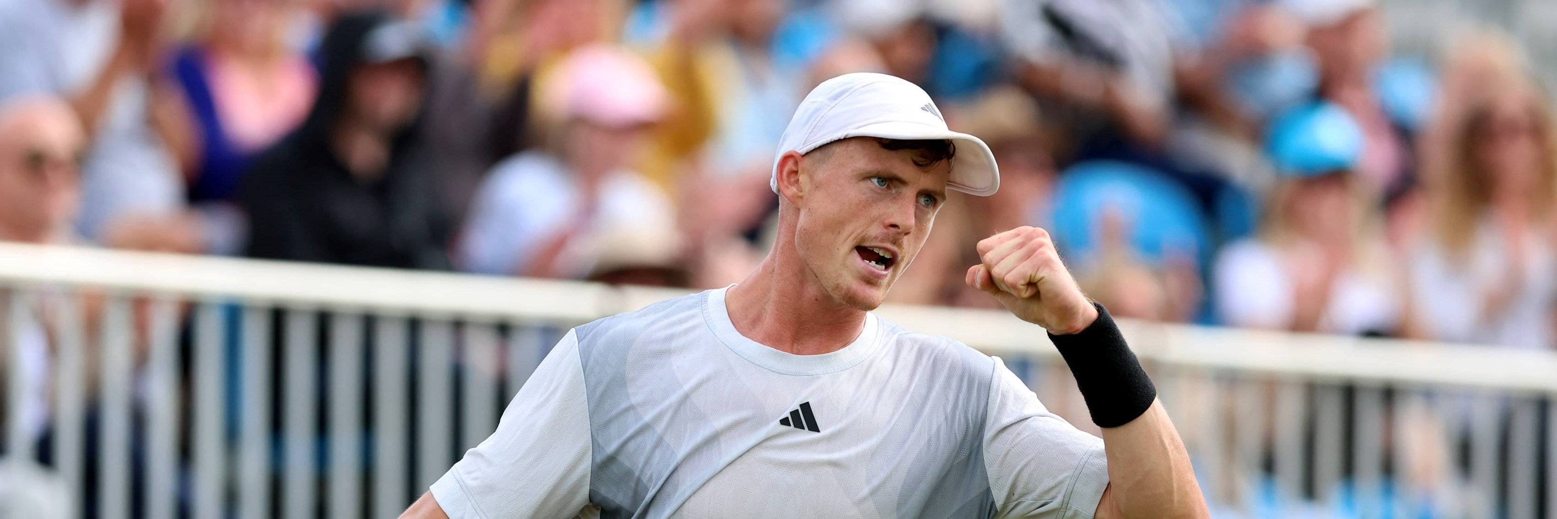 Billy Harris clenching his fist in celebration at the Lexus Surbiton Trophy while wearing Adidas kit