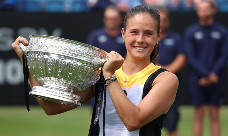 Daria Kasatkina smiling while holding her trophy on court in Eastbourne