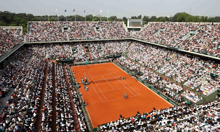 Clay court match with a stadium full of audience