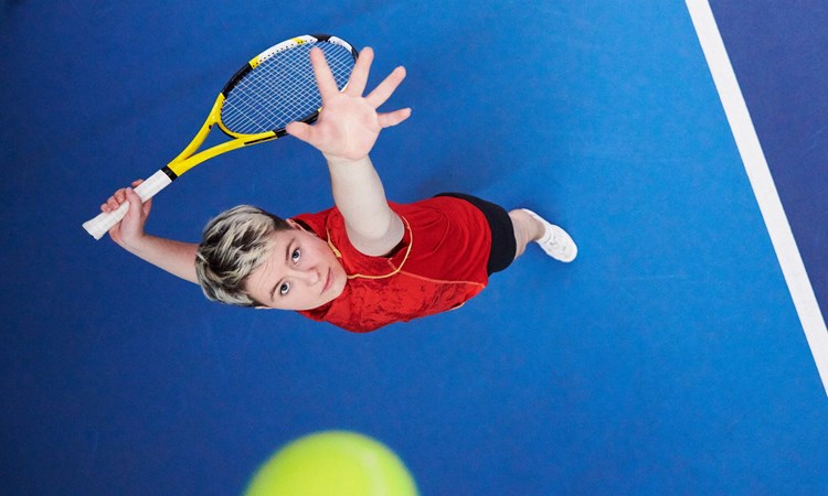 Top view of woman in the middle of a serve