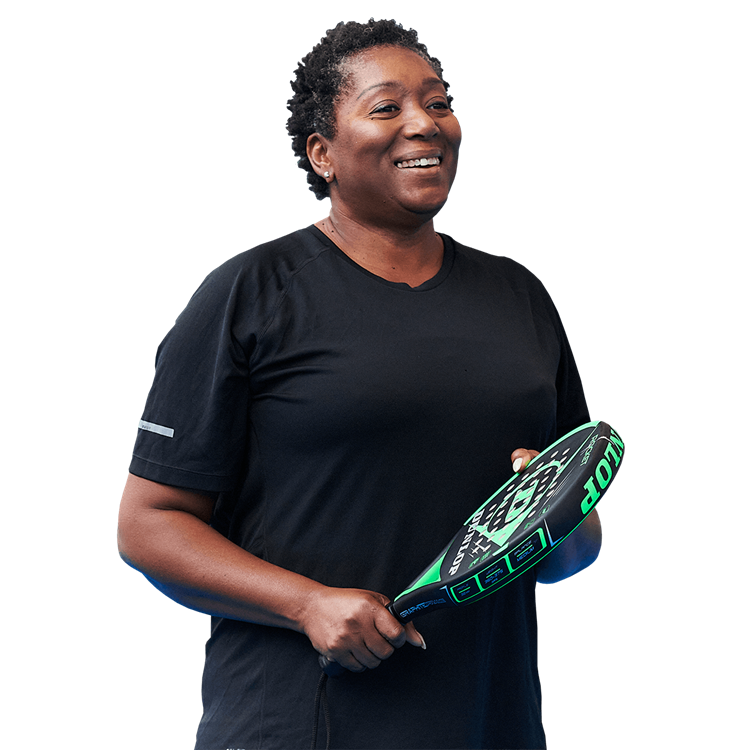 Women smiling holding a padel racket 